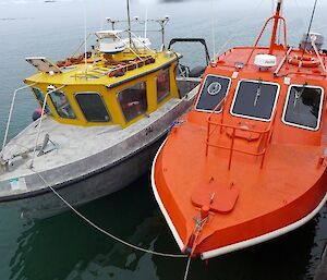 Two boats tied up at the wharf. Both boats are named after people: the Howard Burton and ASV Wyatt Earp.