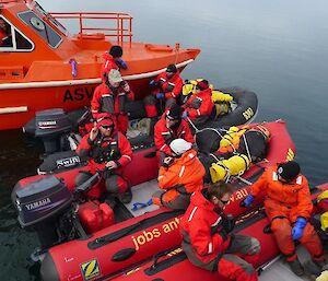 Three inflatable rubber boats are wedge, side-by-side, between the two work boats, for a briefing before we start training.