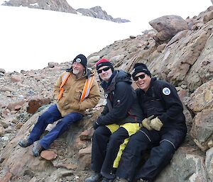 Dave D, Seamus and Vas are leaning against the rocks near Trajer Ridge.