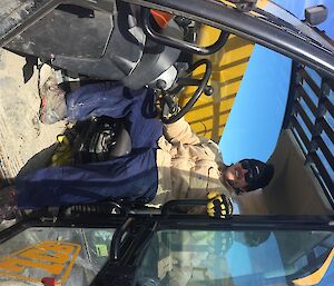 Dr Ralph is posing in the cabin of a digger. He is looking a bit muddy and relaxed.