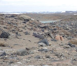 A view of a rocky landscape with the station buildings on the horizon (a very long way to drag cable).