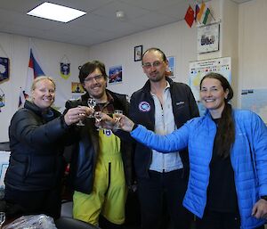 Australian and Russian expeditioners share a toast (“Na zdorovye!”) at the Russian Progress station.