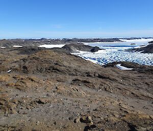A view from a rocky highpoint, down onto a fjord where the sea-ice is rotting out.