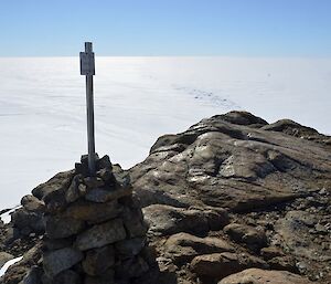 A sign is mounted on the Nunatak, indicating previous visitors.