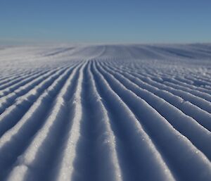 A photo from ground level of the corrugations in the skiway surface, from being groomed.