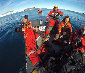 A selfie taken within the Zodiac boat: Pete, Mark, Chris, Fiona and Kirsten, all in mustang flotation suits, cruising amongst icebergs.