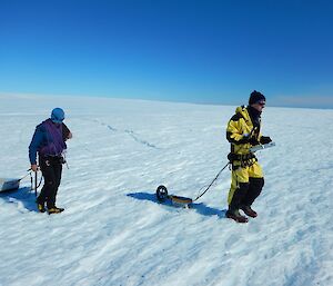 Nick and Tom are dragging a ground penetrating radar system across the glacier’s surface.