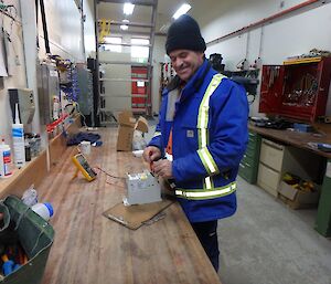 Barry is working inside the electricians workshop on station. You can see tools lining the walls.