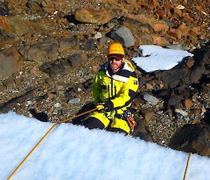 Fitzy is descending an ice cliff during crevasse rescue training.