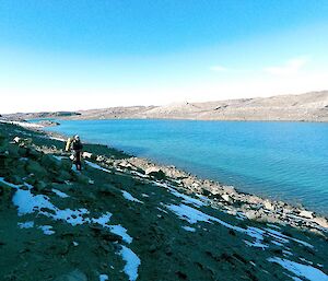 Daleen can be seen walking along the rocky slope of the very large Lake Stinear.