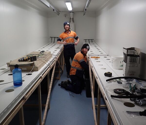 Bryce, and electrician, and Shoey, a plumber, are seen working on the electronics and plumbing systems in the growing channels of the hydroponic chambers. Everything is new and built from scratch.