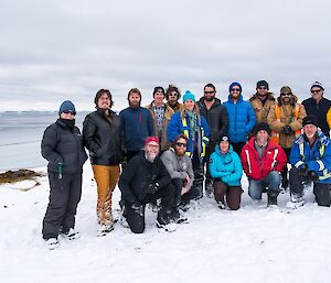 The winter team back row (L-R): Kirsten, Ralph, Sharky, Rob, Lotter, Kerryn, Marc, Bryce, Jock, Tony, Barry B2, Fitzy; front row: Barry B1, Shoey, Daleen, Rhys and Richard. In the background are the resident elephant seals and newly formed sea-ice in the bay.