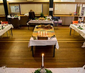 The table are all laid with white table clothes and decorated with herbs. The tables are in a crescent formation for the occasion.