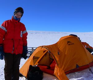 Daleen is standing in front of a tent out on the Antarctic Plateau.