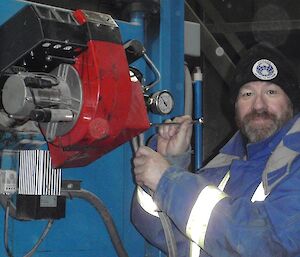Fitzy is operating the incinerator controls on the station’s incinerator.