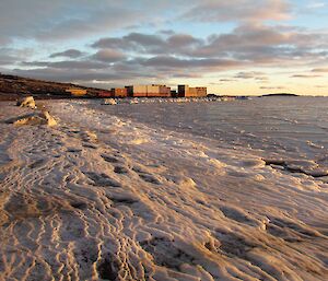 The ice has formed in a woodgrain type pattern along the beach edge as it freezes and accumulates over time.