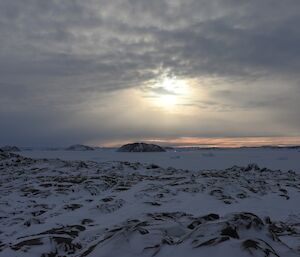 A landscape shot of the brown hills of Davis with frozen sea-ice in the distance, surrounding islands.