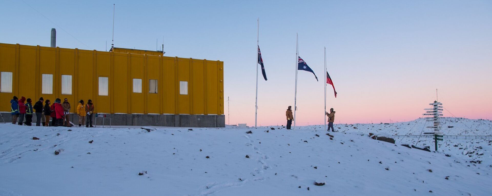 The Australian, New Zealand and Aboriginal flags are raised for ANZAC Day.