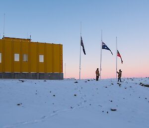 The Australian, New Zealand and Aboriginal flags are raised for ANZAC Day.