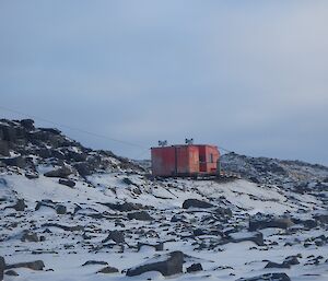 The red building of Brookes Hut nestled in the Vestfold Hills.
