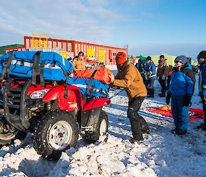 The team try, unsuccessfully, to pull the bike out using ropes alone.