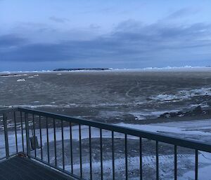 The sea-ice off shore is brown. Covered in dirt blown out from the local hills in the blizzard.