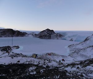 A view of Platcha Hut nestled in Breid Basin, up by the plateau. Quad bikes are parked near the hut.