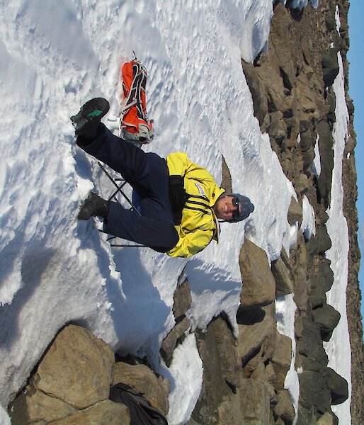 Ralph is sitting in a deck chair, on the snow at Marchant’s Landing.