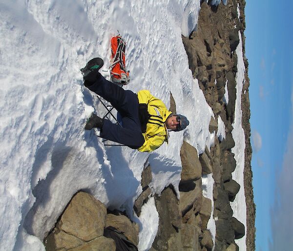 Ralph is sitting in a deck chair, on the snow at Marchant’s Landing.