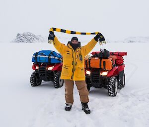 Barry (B1) holds a rugby scarf above his head, showing team support.