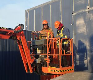 Bryce and Rhys are in the elevated work platform having reattached the side panel to the Powerhouse. They are coming back to ground level now the job is done.