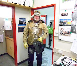 Jock arrives at the workshop office, covered in snow and ice.
