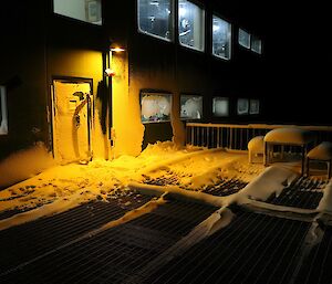 A shot of the door into the Living Quarters building, covered in snow and dark.