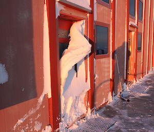 Layers of snow peel off the workshop door once it heats up again.