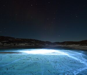 An LED light has been placed in a hole in the ice which has lit up all the cracks — great for photography.