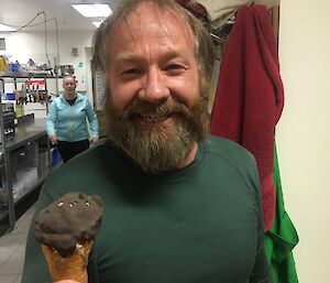 Fitzy is in the kitchen, holding a home made choc top ice cream. He looks very happy as he has scored the last one.