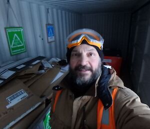 Tony at the cardboard recycling container.