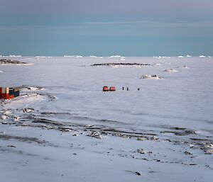 The site for the pool is selected. A Hagg and three people are seen down on the sea-ice.