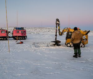 The big auger in action, drilling into squares of ice to aid with removal.