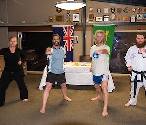 Four expeditioners strike a pose after their TaeKwon-Do grading.