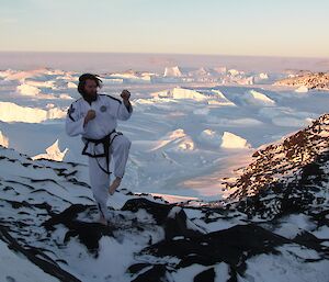 Sharky is in his TaeKwon-Do uniform, striking a pose at Bandits. In the background are icebergs and the Antarctic Plateau.