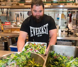 Marc with the hydroponics harvest grown especially for the Midwinter dinner. He has three bowls of salad in front of him.