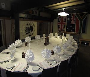 The table set for dinner. Richard’s sculpture provides the artwork, while the flags of other nations are hung around the room in the Midwinter tradition going back to Scott’s time.