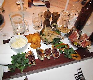 Plates full of entree food ready to share.