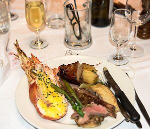 A mixture of mains: lobster, duck, lamb, pork belly and vegetables.