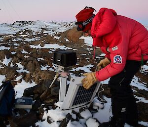 Lötter inspecting the solar panel for the automated sea ice camera.