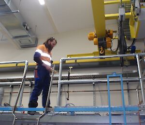 Sharky (electrician) examining machinery in the treatment plant.