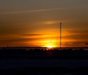 A yellow sun can be seen just poking above the horizon.