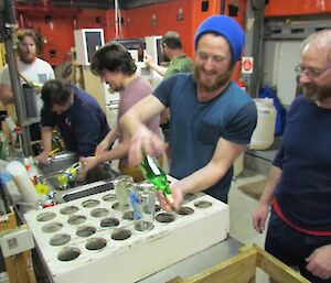 Washing the beer bottles in preparation for bottling the beer.