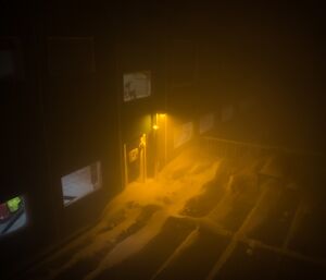 Watching the blizzard from the warmth of the living quarters. Lots of swirling snow in darkness.